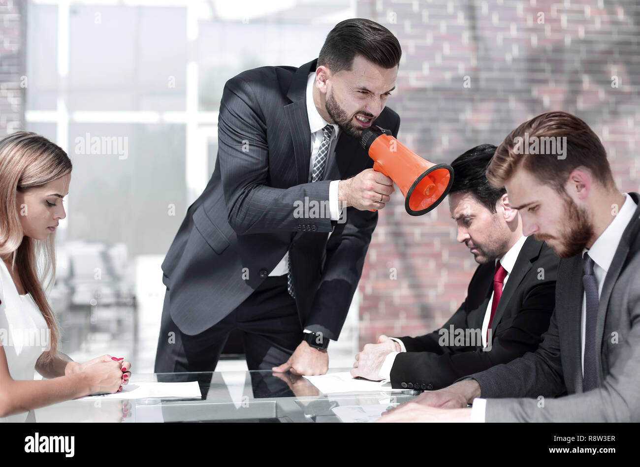 businessman yelling through a megaphone during a meeting Stock Photo