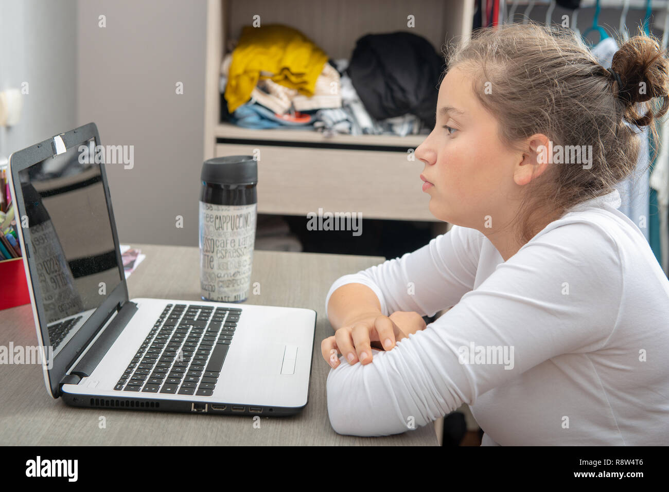 a pretty teenage girl doing homework on the desk Stock Photo - Alamy
