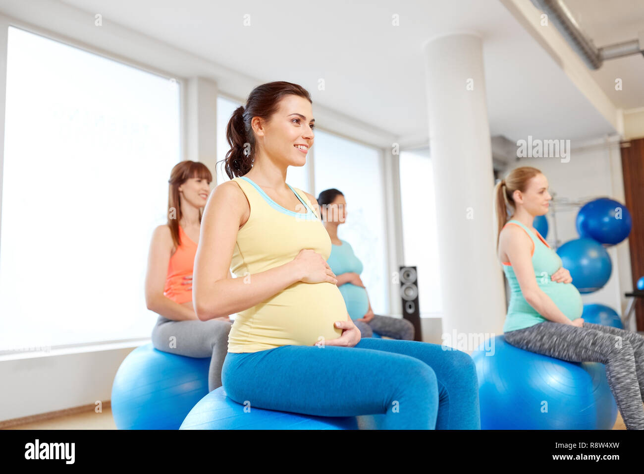 pregnant women sitting on exercise balls in gym Stock Photo Alamy