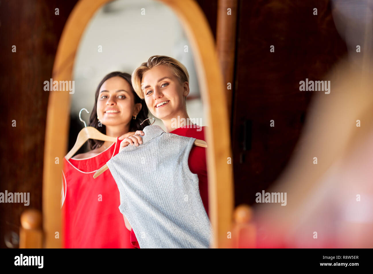 women choosing clothes at vintage clothing store Stock Photo