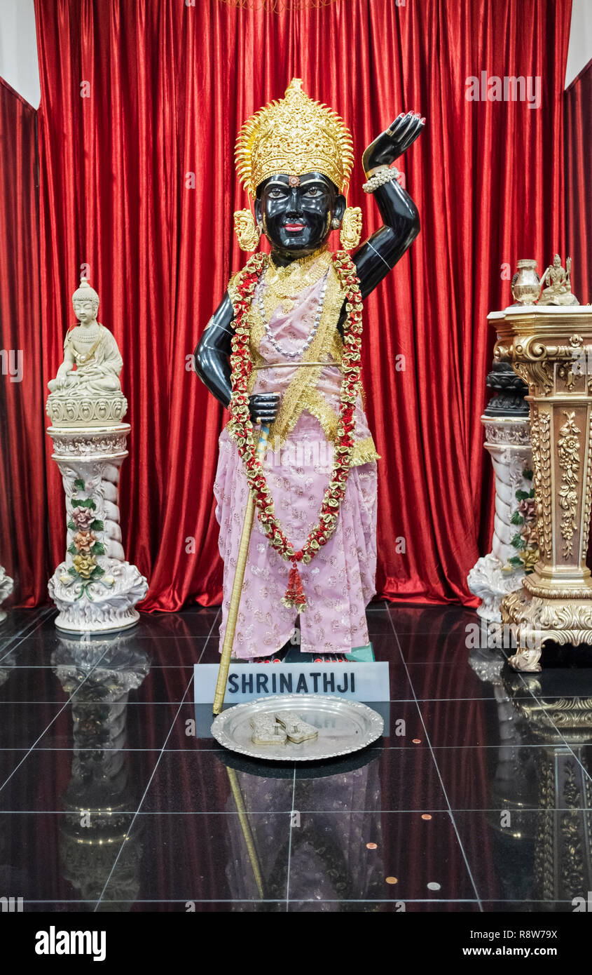 A statue of the god Shrinathji, a manifestation of Krishna.  At the alter inside the Geeta Temple in Corona, Queens, New York City Stock Photo
