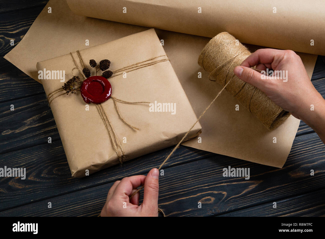 Process of package gift wrapped in craft paper with string and ...