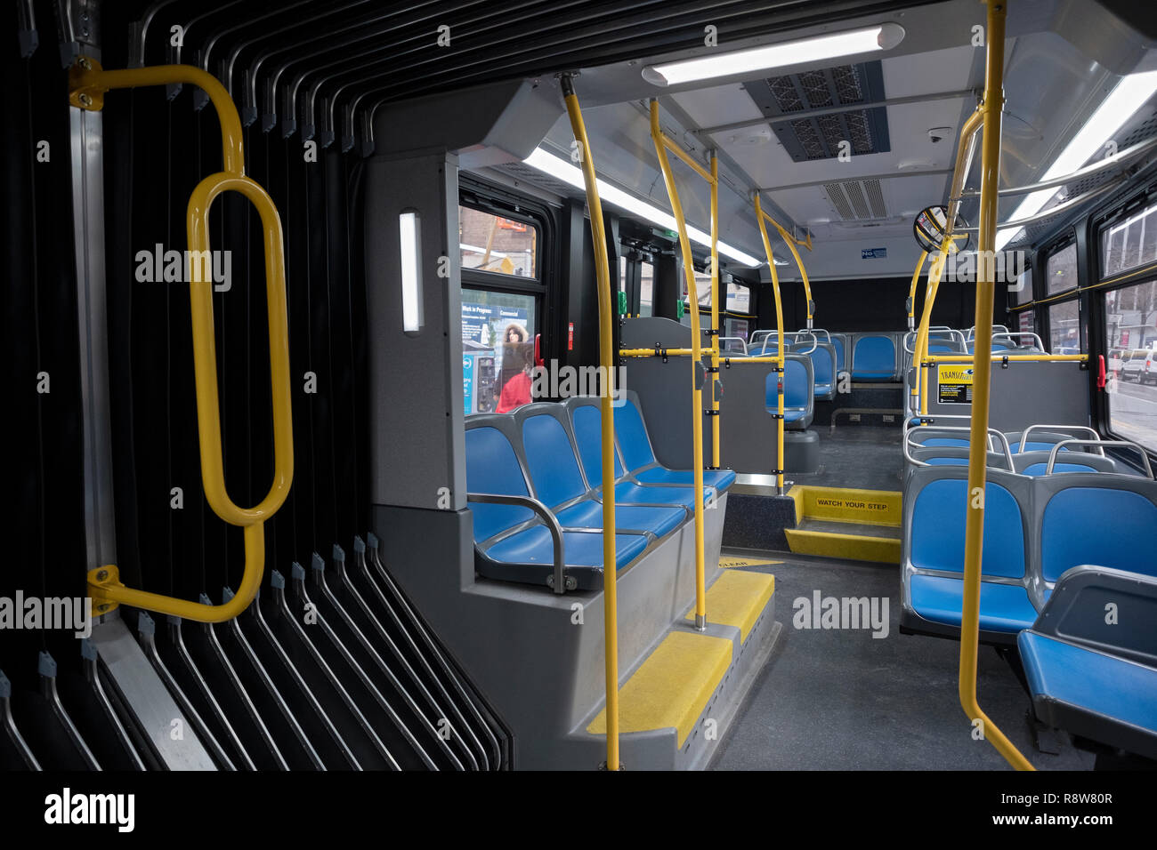 the interior rear of one of New York City's new articulated accordion buses traveling west on 34th Street in Midtown Manhattan. Stock Photo