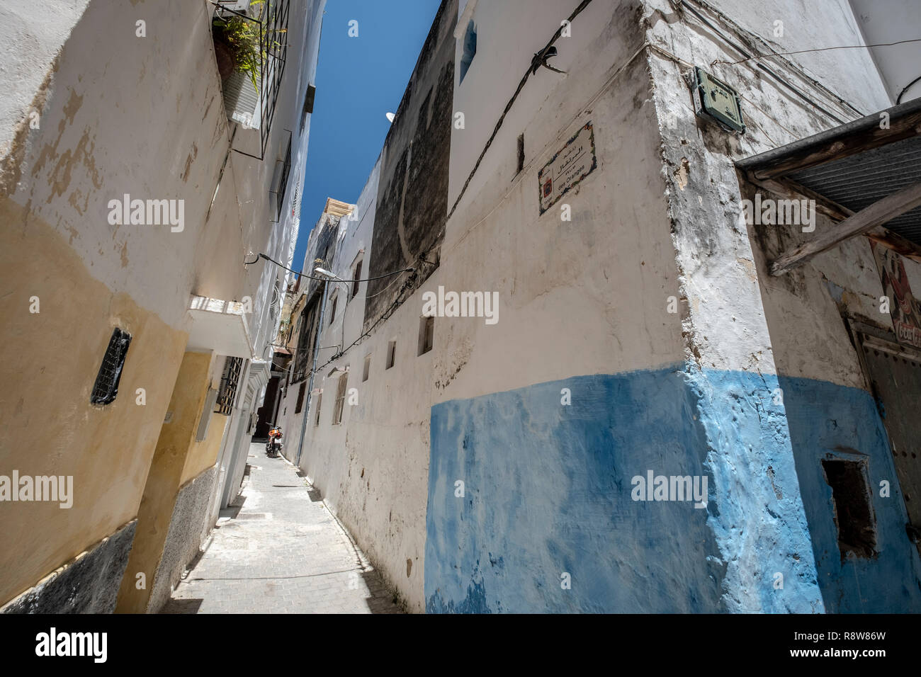 Ancient blue painted alley with old door entrance in the medina of Tanger (Tangier), northern Morocco Stock Photo