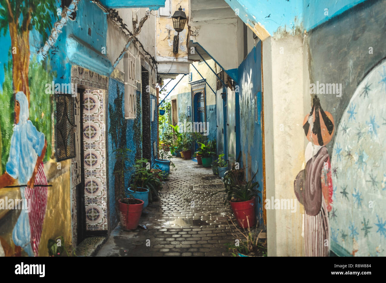Ancient blue painted alley with old door entrance in the medina of