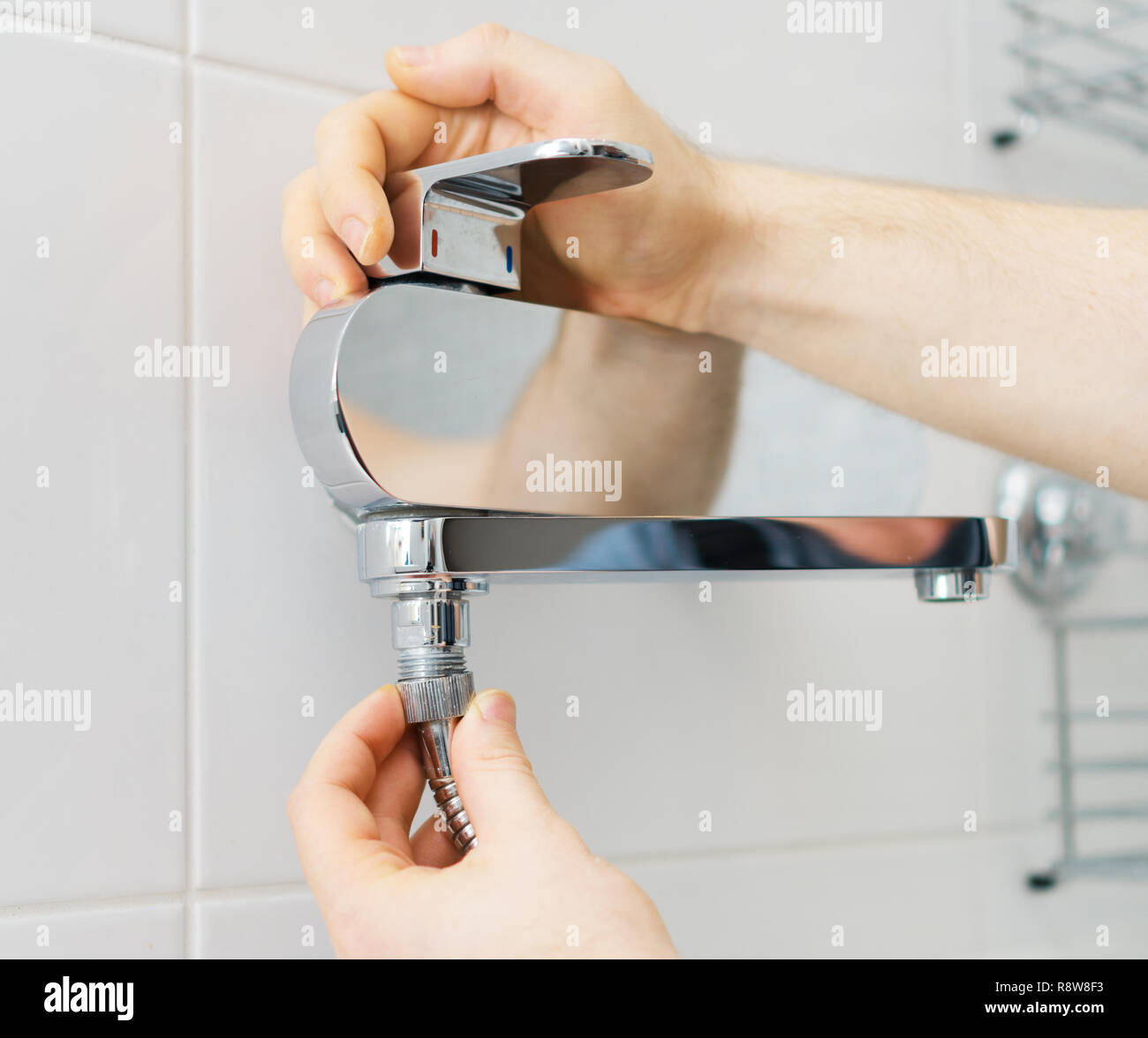 Plumber hands fixing shower mixer on modern water tap Stock Photo Alamy
