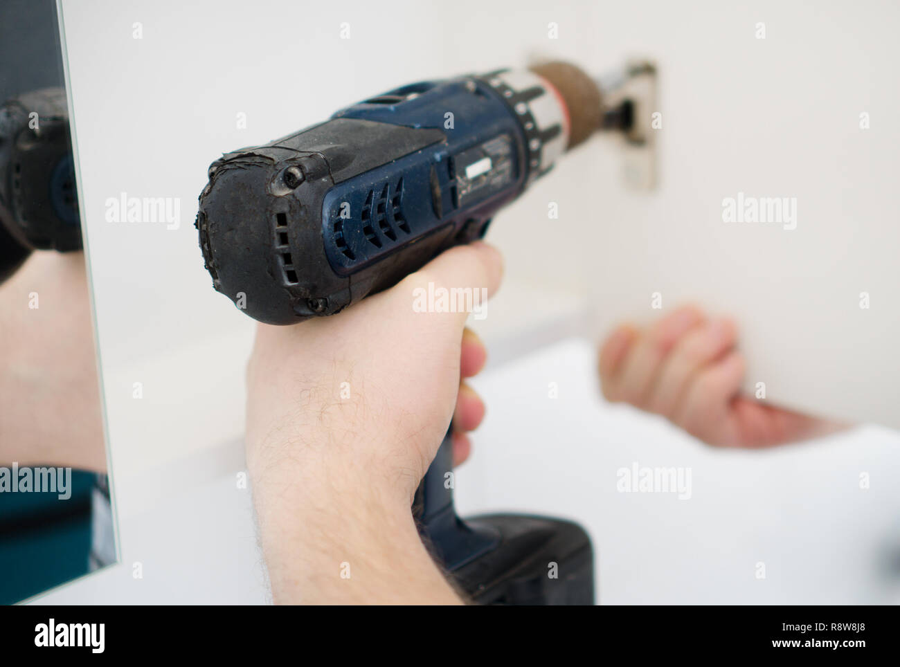 Handyman installing door in bathroom Stock Photo Alamy