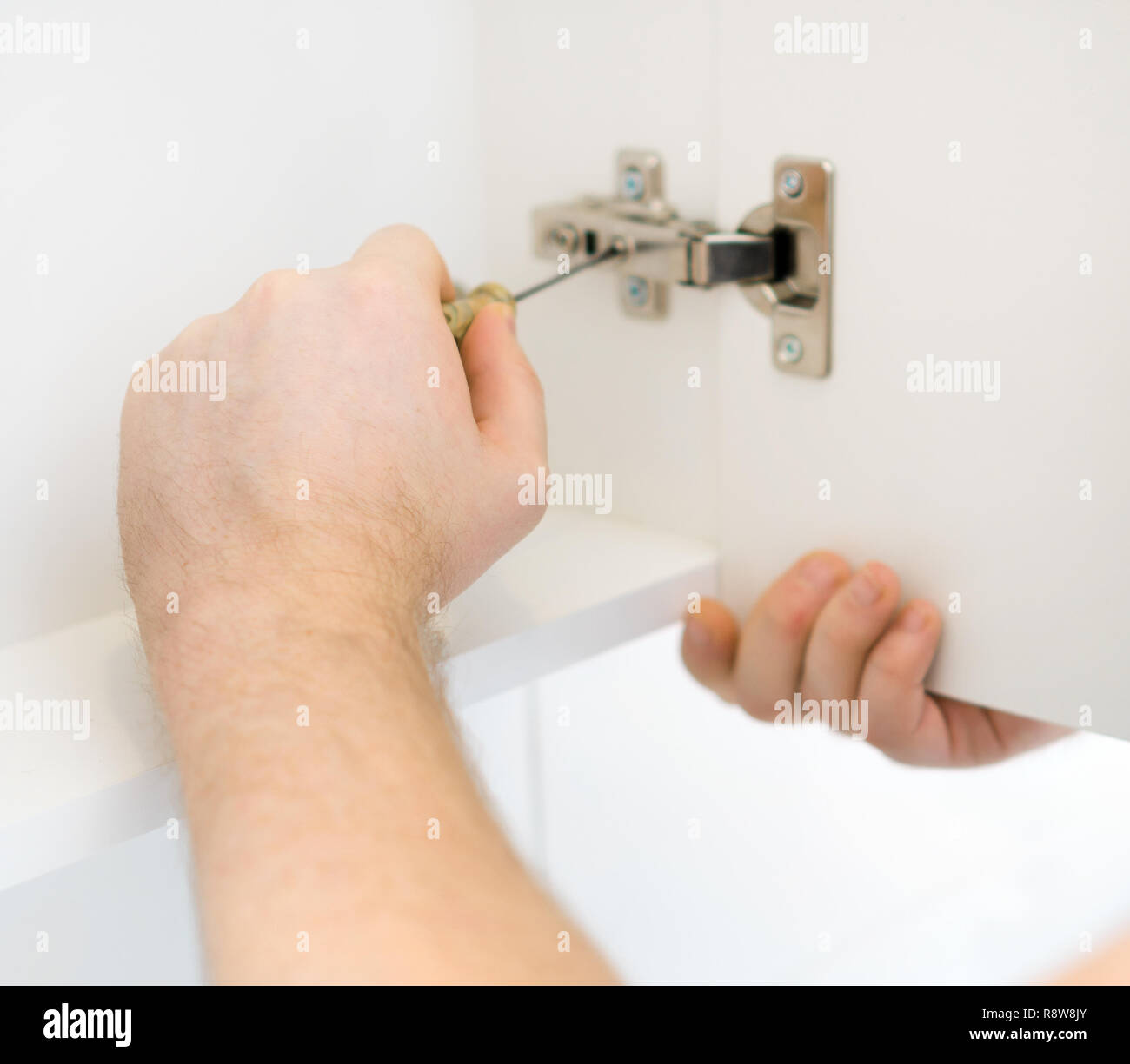 Handyman installing door in bathroom Stock Photo Alamy