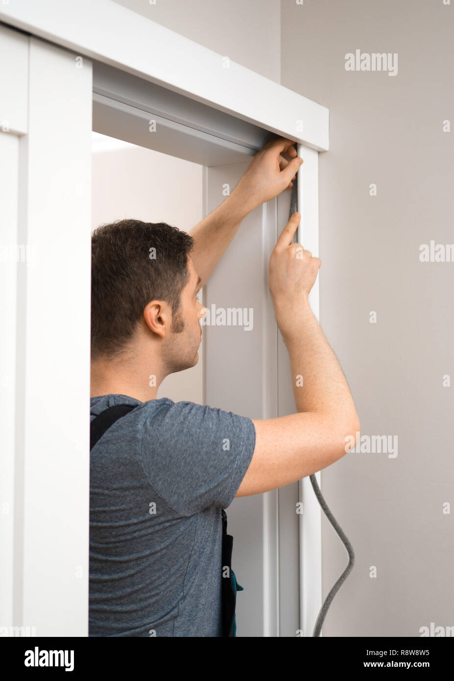 Handyman installing sliding door at home Stock Photo Alamy