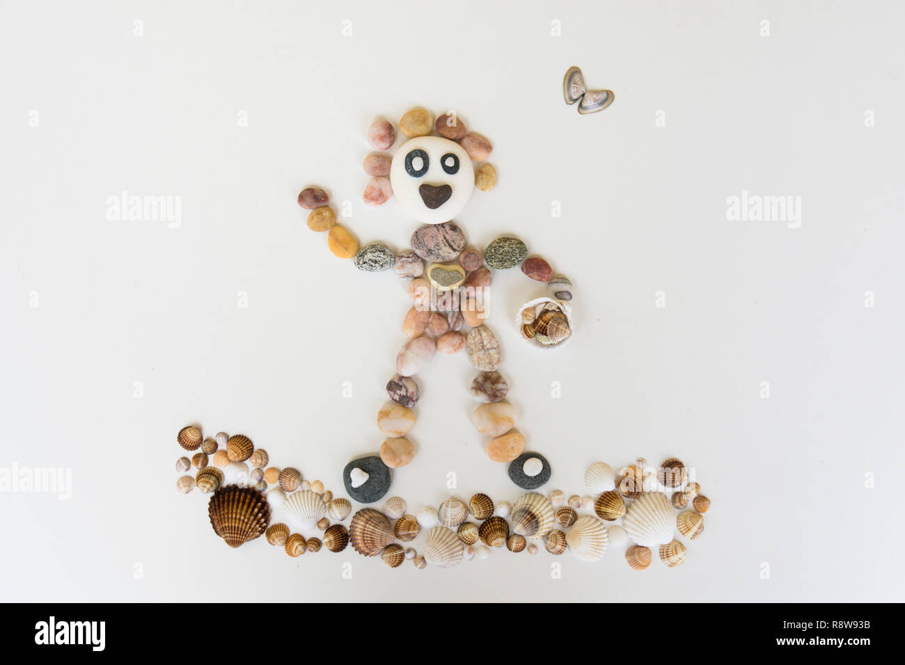 natural art, craft, picture of person surfing, made from pebbles, shells, Stock Photo