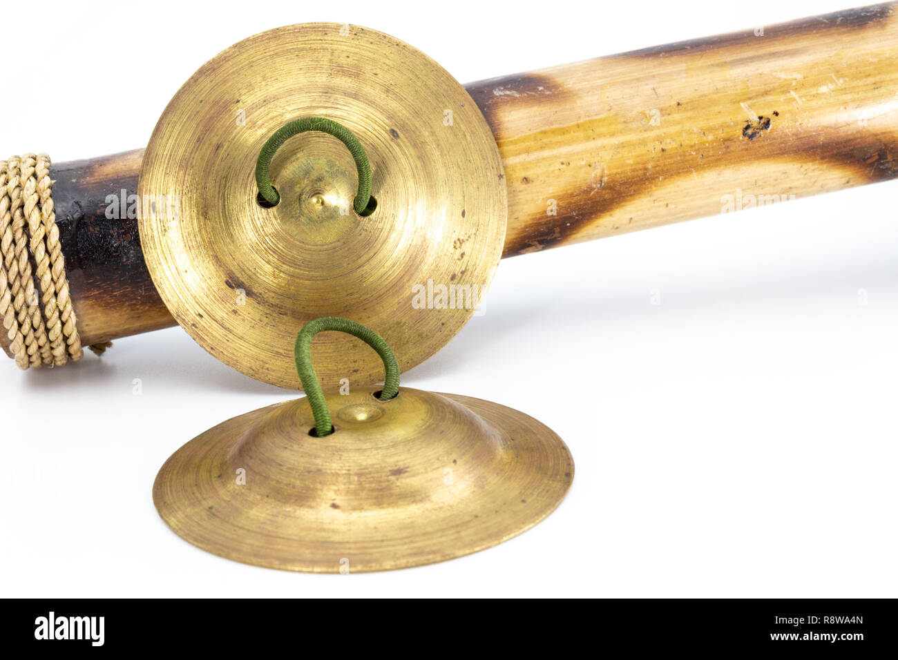Indian finger cymbals with green rubber handle, studio photo Stock Photo