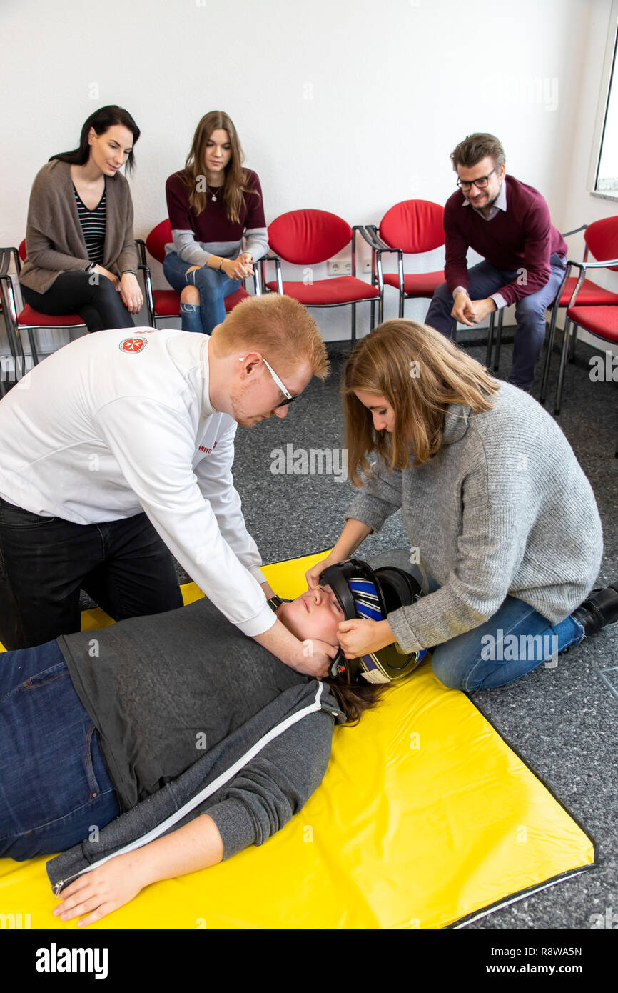 First aid course, first aid training in case of accidents, emergencies, practice training, proper removal of the safety helmet in the case of an accid Stock Photo