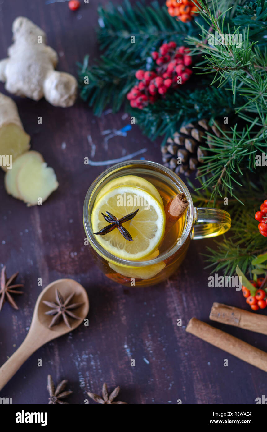 Yellow colored lemon ginger tea with all its ingredients in dark Gothic ...
