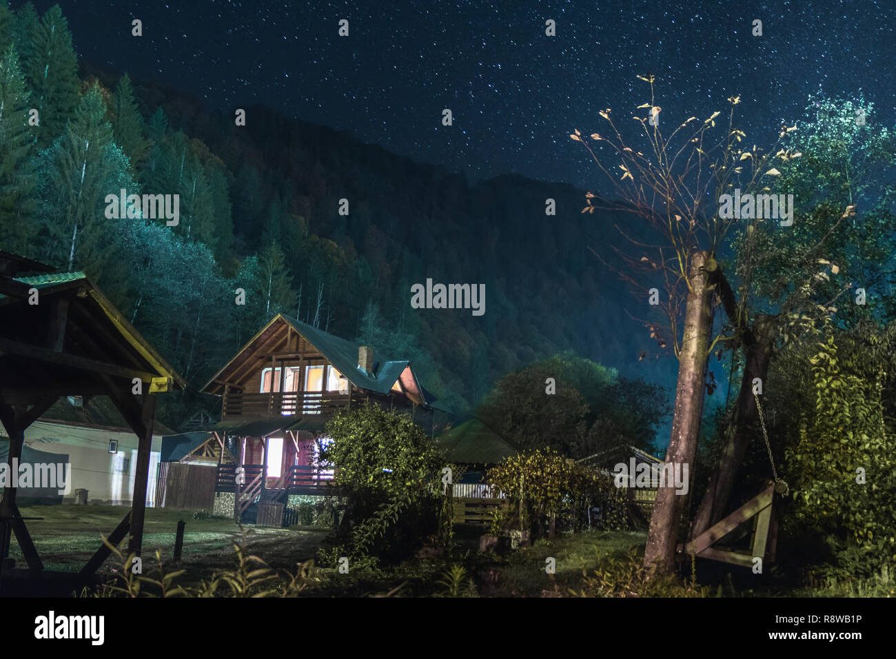 A house in the mountains and stars Stock Photo