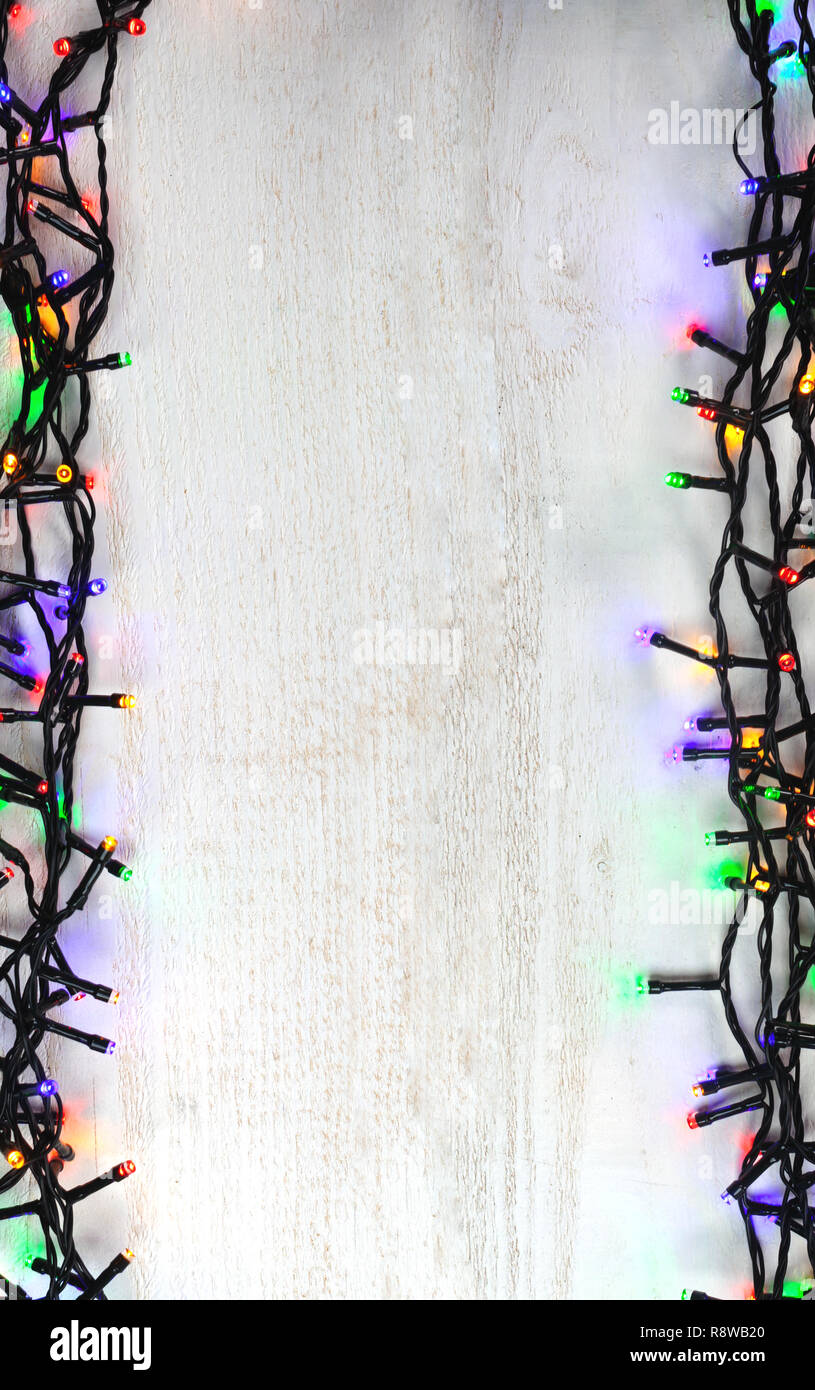 Christmas lights bulb frame decoration on white wood. Merry
