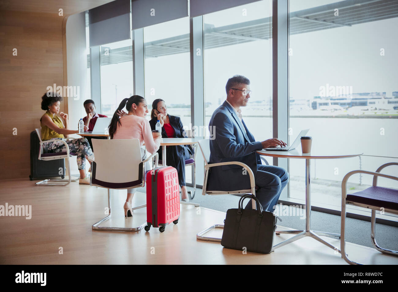 Business people working in airport business lounge Stock Photo - Alamy