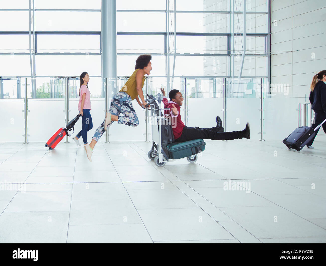 Pushing luggage cart hi-res stock photography and images - Alamy