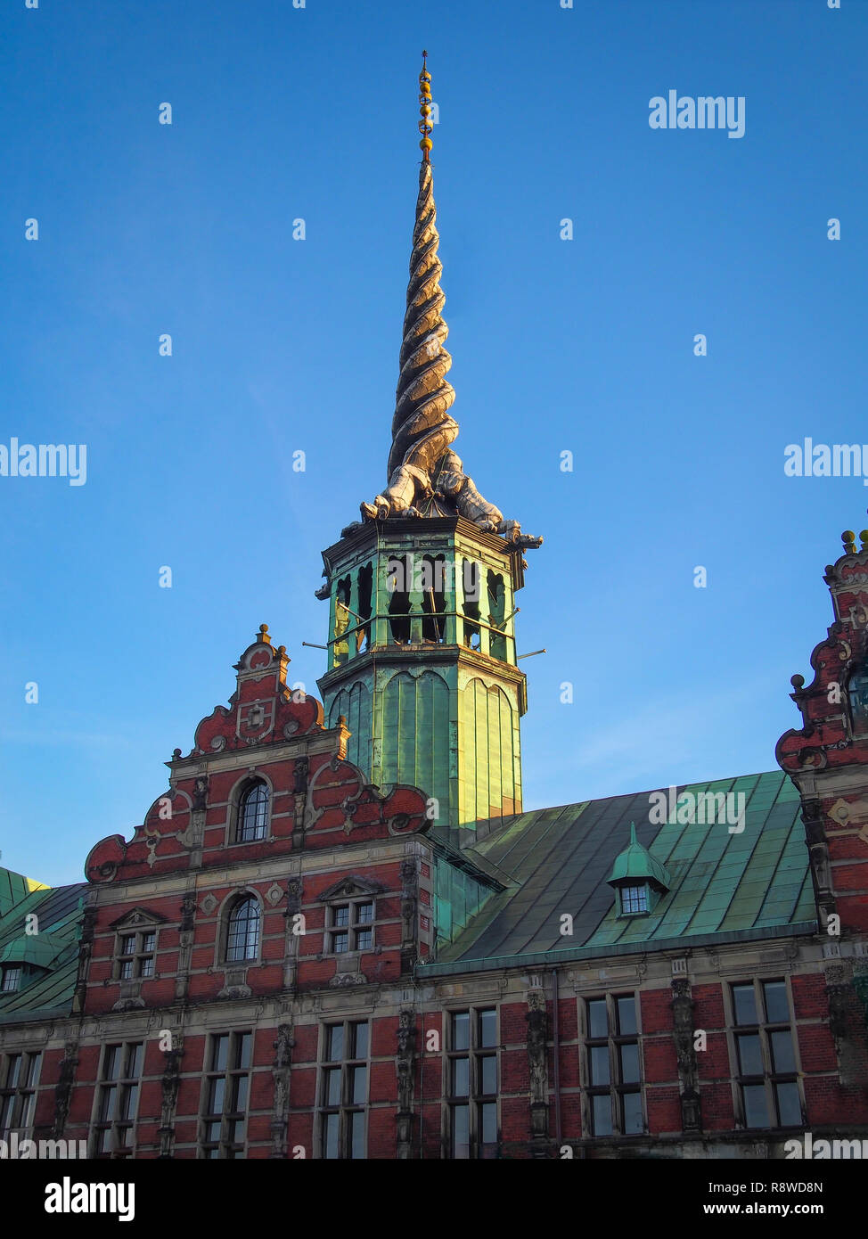 Spire of Borsen building, shaped as the tails of dragons twined together in twiligh. Copenhagen, Denmark Stock Photo