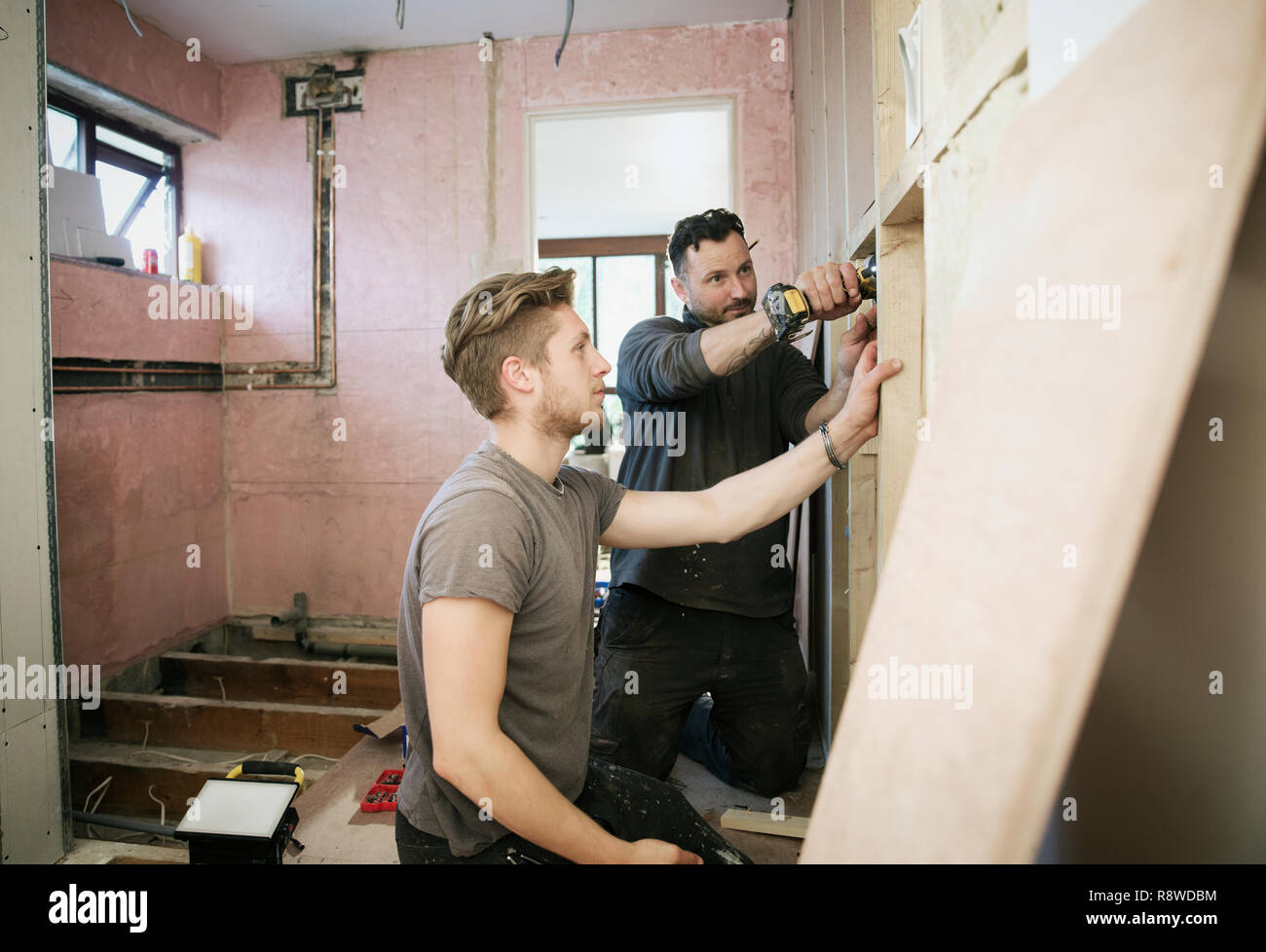 Construction workers framing inside of house Stock Photo