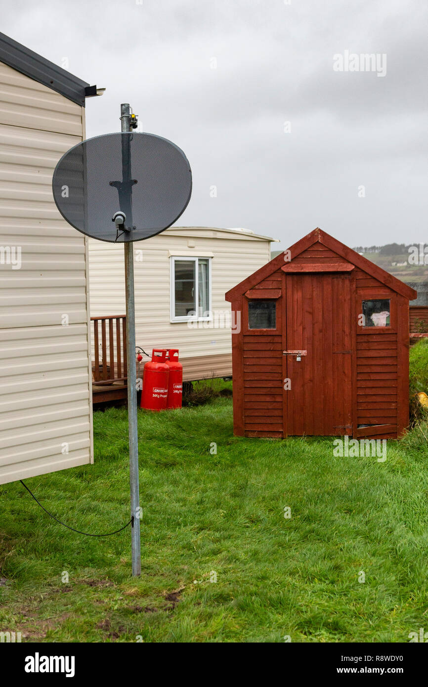 TV satellite dish on mobile home in caravan park, Ireland Stock Photo