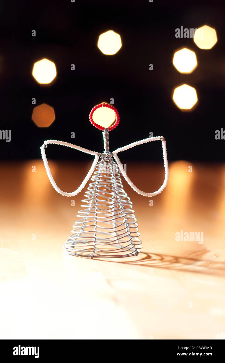Christmas Angel decoration against background bokeh lights. Stock Photo