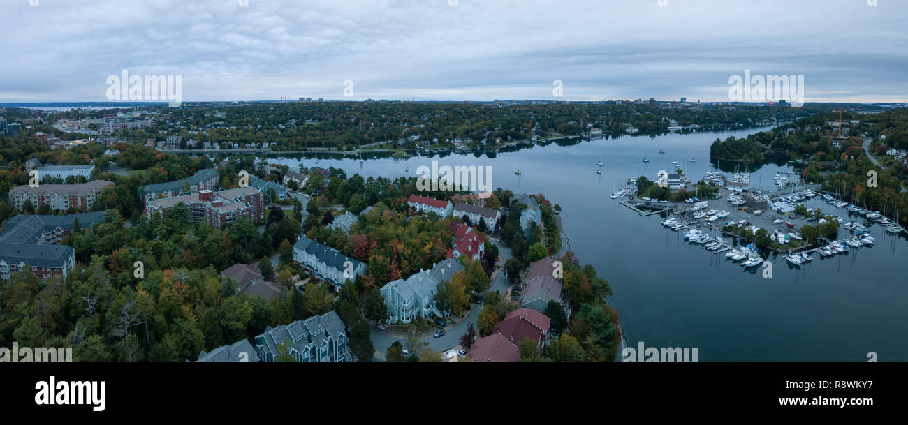 Aerial panoramic view of Melville Cove in the Modern City during a cloudy sunrise. Taken in Armdale, Halifax, Nova Scotia, Canada. Stock Photo