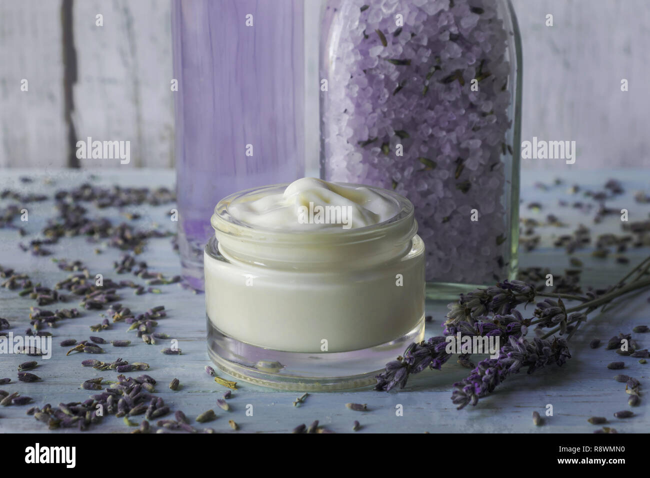 Homemade lavender facial cream on a white wooden background With salts