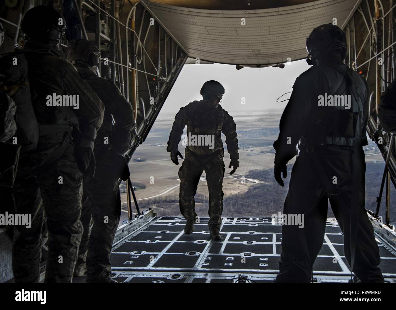 Master Sgt. Ed Dewejko, 19th Operational Support Squadron Survival, Evasion, Resistance and Escape superintendent, prepares for a static line jump from a Lockheed C-130 Hercules above the drop zone at Scott Air Force Base, Illinois March 2, 2017. The drop zone is a new addition to the airfield enhancing capabilities to conduct a diverse set of operations. Stock Photo