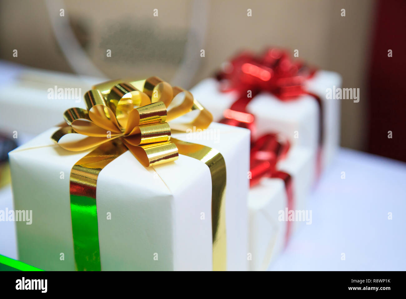 present boxes package with gold and red ribbons as holiday gift boxes ...