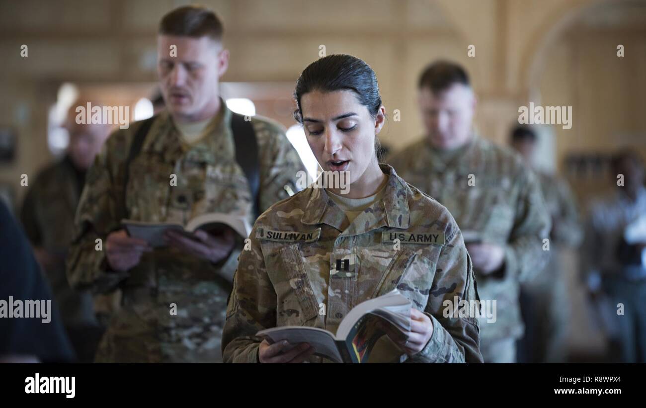 Service members, Defense Department civilian employees and contractors sing during a service March 12, 2017 at the Fraise Chapel, Kandahar Airfield, Afghanistan. In addition to chapel services, the 455th Air Expeditionary Wing chaplain provides counseling, enhances morale and provides accommodations for all faiths throughout the units assigned at Kandahar. Stock Photo