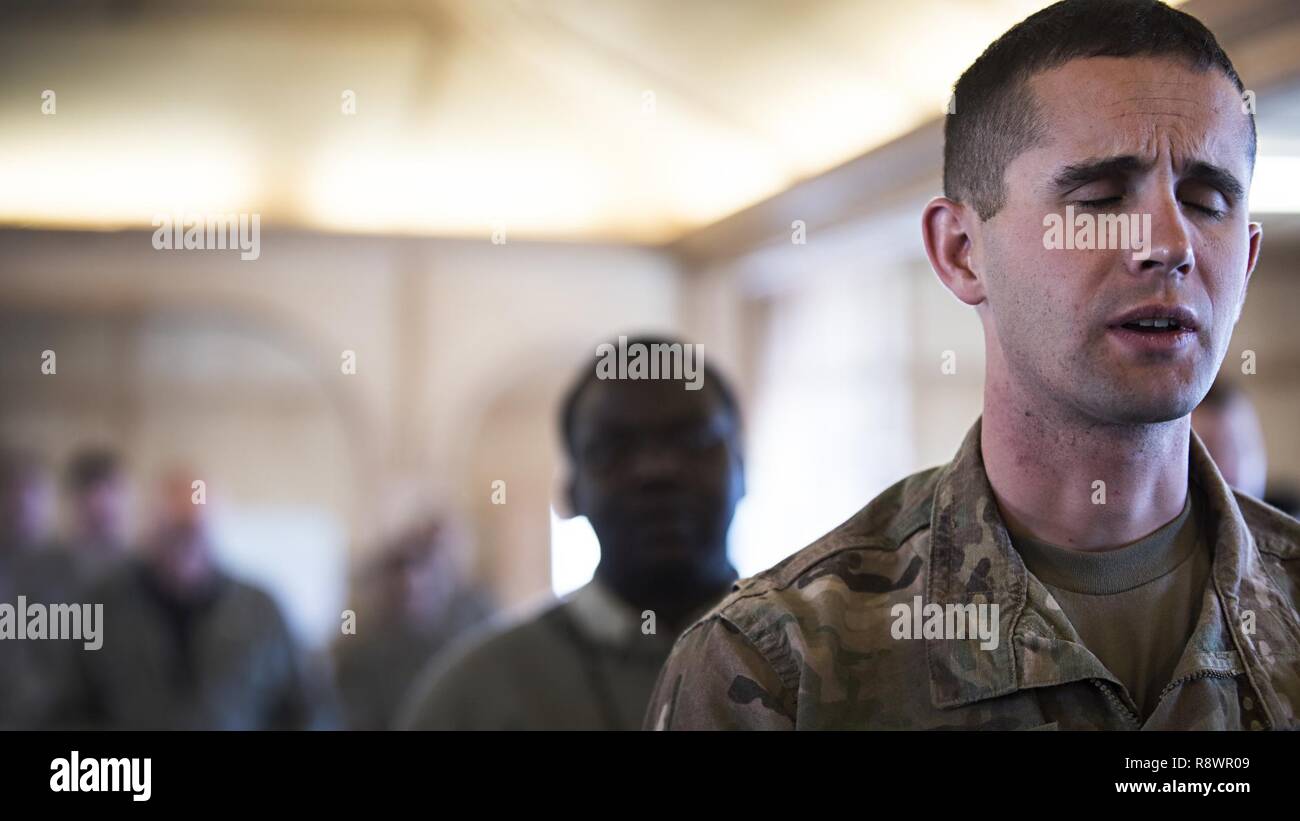 Capt. Trevor Waliszewski, 3rd Brigade Combat Team, 101st Airborne Division, sings during Sunday Mass March 12, 2017 at the Fraise Chapel, Kandahar Airfield, Afghanistan. In addition to chapel services, the 455th Air Expeditionary Wing chaplain provides counseling, enhances morale and provides accommodations for all faiths throughout the units assigned at Kandahar. Stock Photo