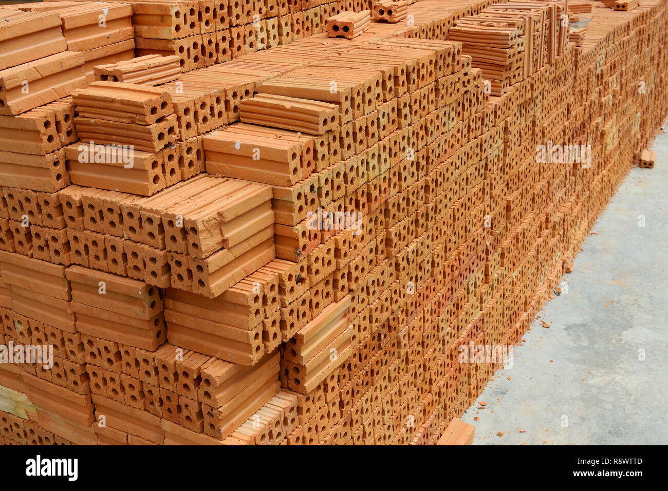 Stack of red bricks, bricks used for building construction Stock Photo