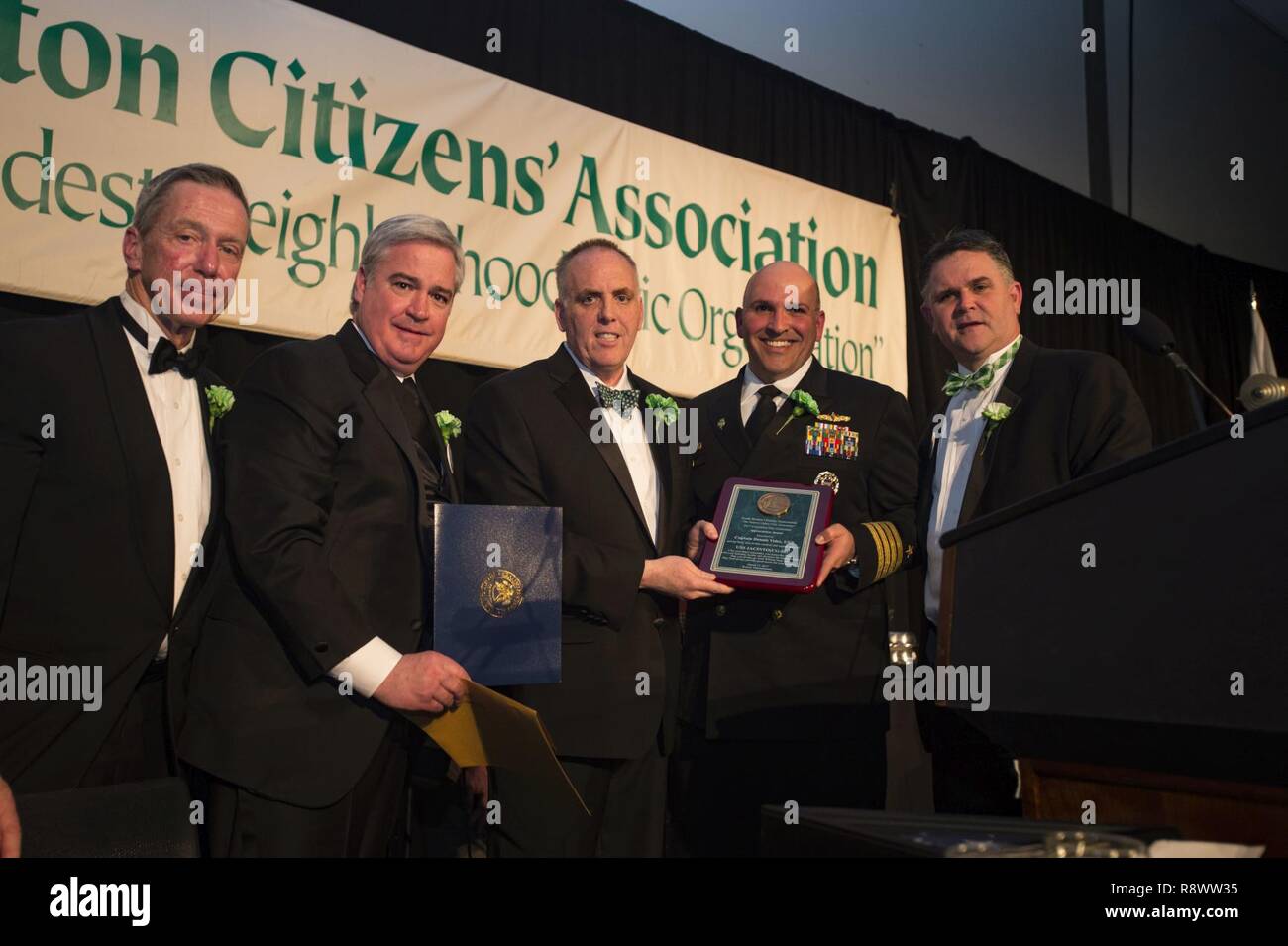BOSTON (March 17, 2017) The guide-missile cruiser USS San Jacinto (CG 56) Commanding Officer Capt. Dennis Velez is receives an appreciation award by the South Boston Citizen’s Association Evacuation Day Banquet. USS San Jacinto (CG 56) participates in Boston's, St. Patrick’s Day festivities and community programs throughout the city. Stock Photo