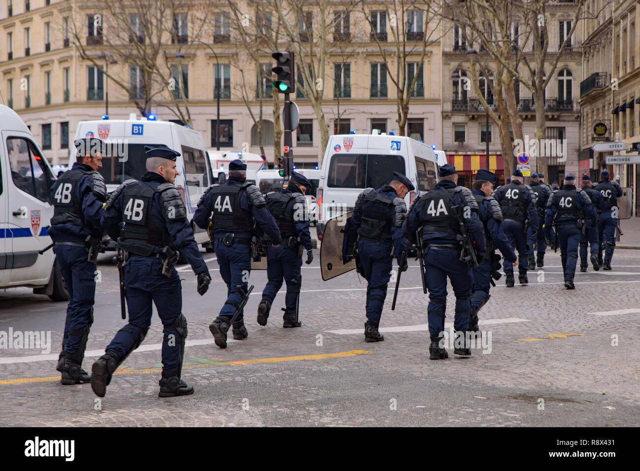 Riot police for the Yellow Vests demonstration (Gilets Jaunes) protesters against government, and French President at Champs-Élysées, Paris, France Stock Photo
