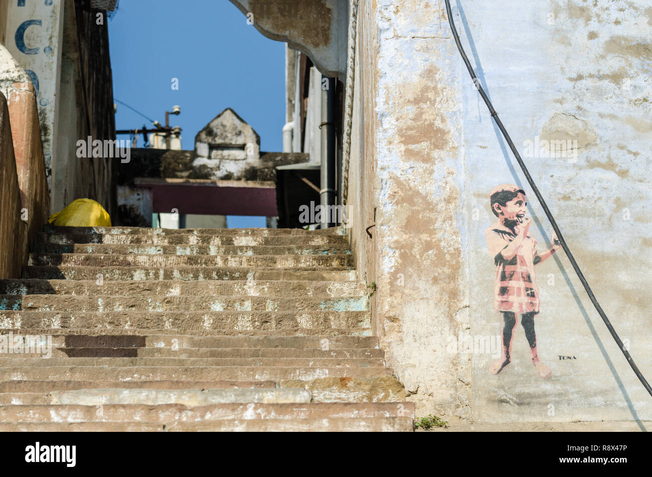 Graffiti of a young boy by German street artist Tona at one of the ghats in Varanasi, Uttar Pradesh, India Stock Photo