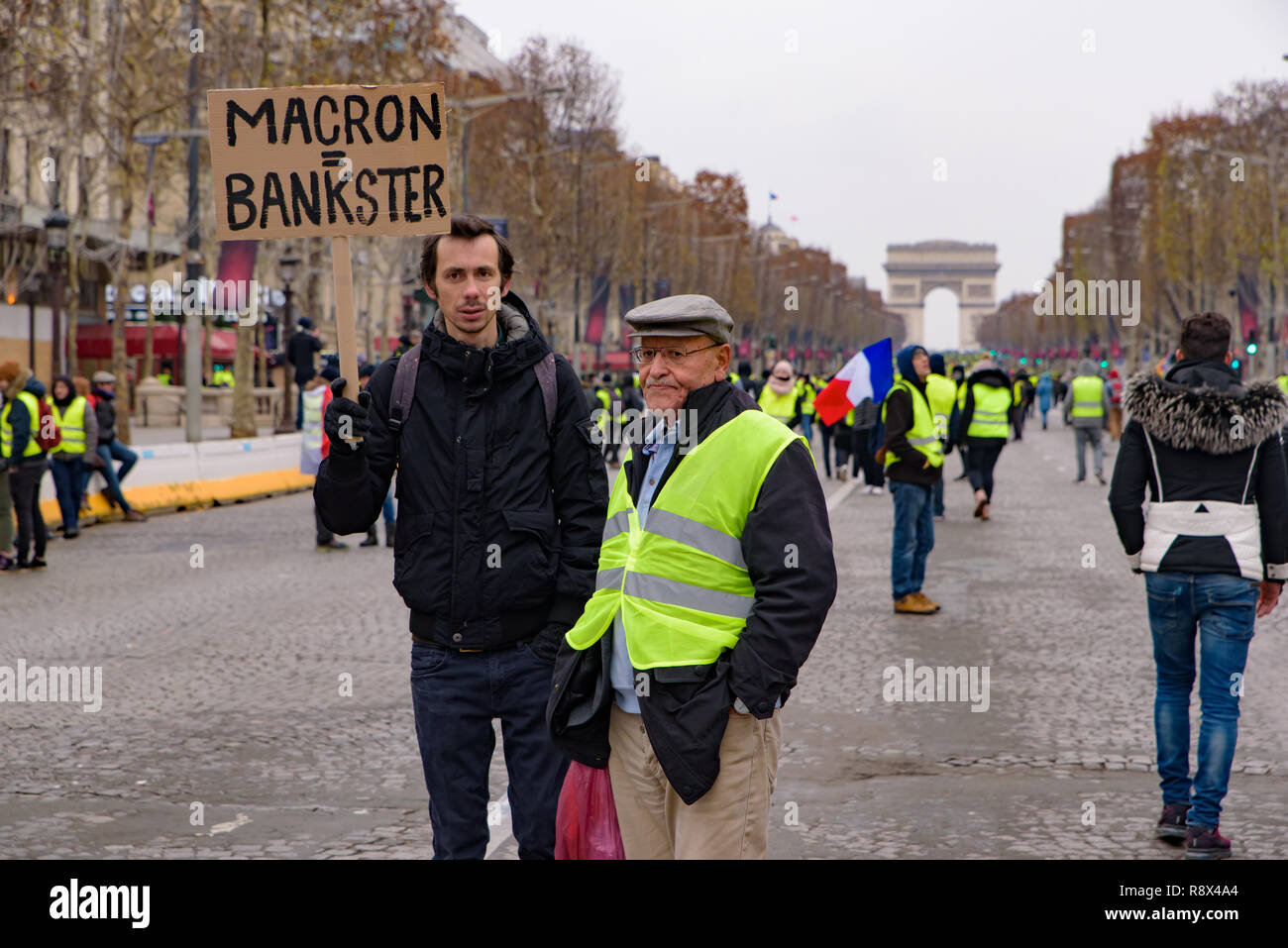 5th Yellow Vests demonstration (Gilets Jaunes) protesters against fuel tax, government, and French President Macron with slogan at Champs-Élysées Stock Photo