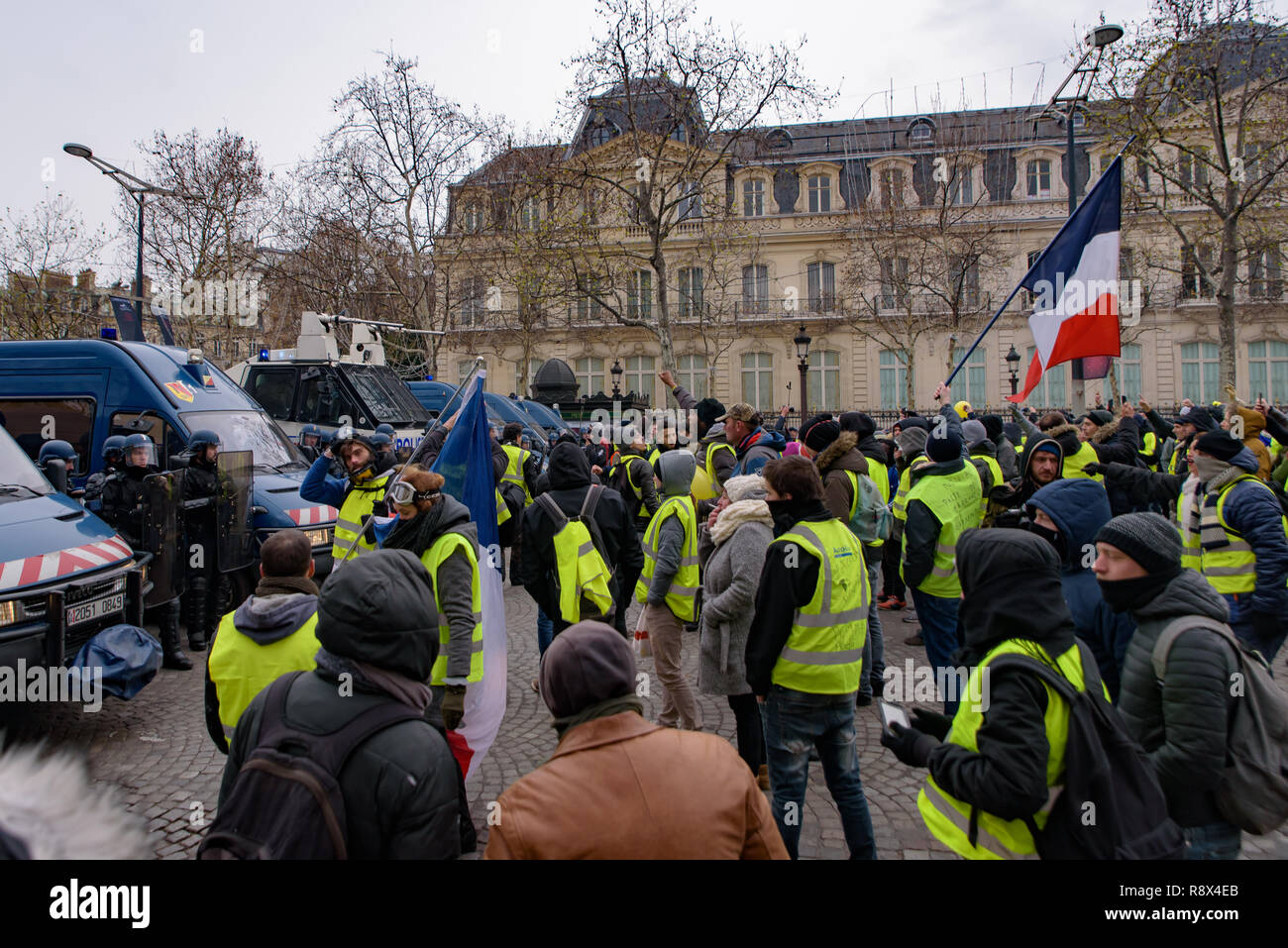 Riot police and Yellow Vests demonstration (Gilets Jaunes) protesters against government and French President Macron at Champs-Élysées, Paris, France Stock Photo