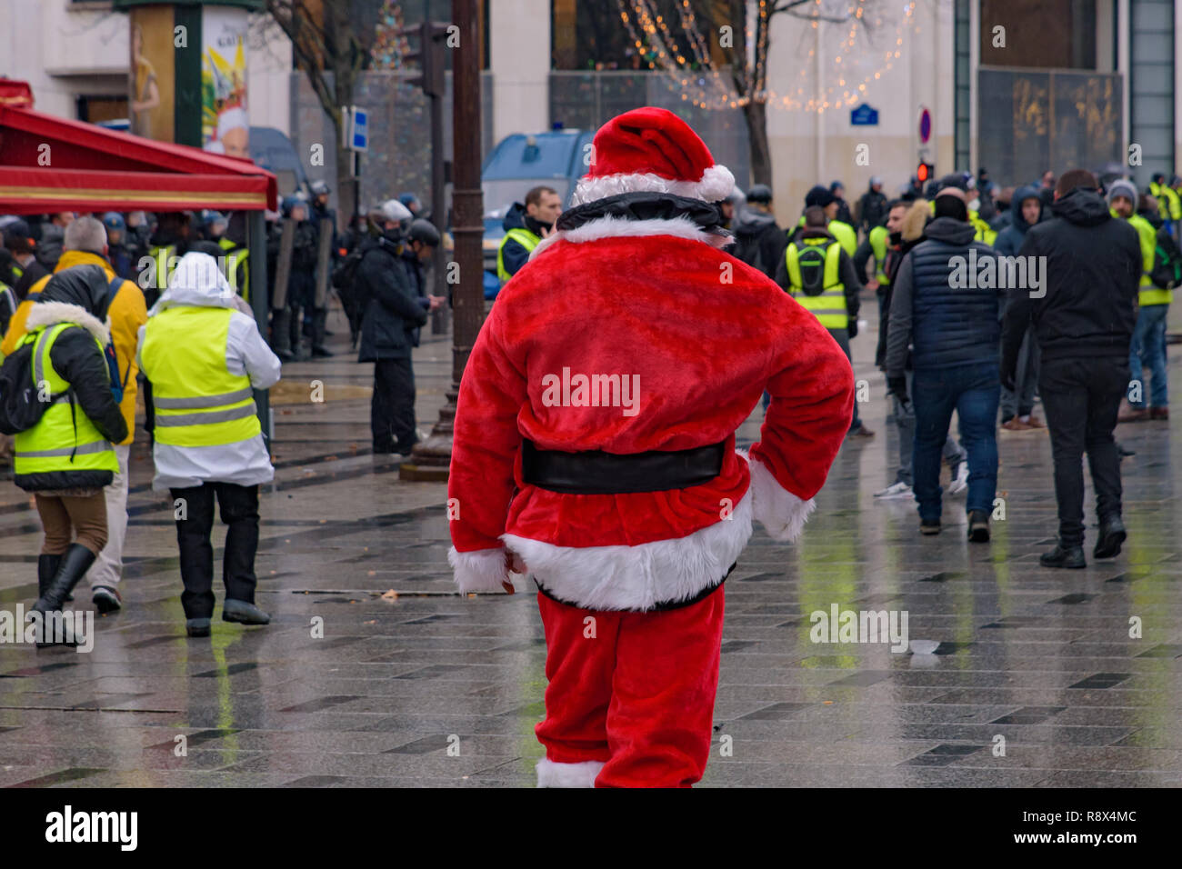 Protester of the 5th Yellow Vests demonstration (Gilets Jaunes) against fuel tax, government, and French President Macron dressing in Santa Claus at C Stock Photo