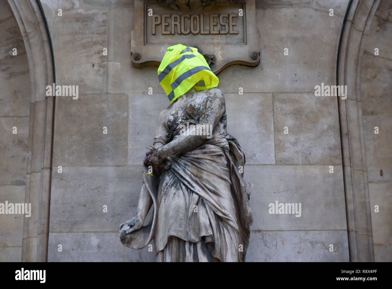 Protesters of Yellow Vests demonstration (Gilets Jaunes) against government, and French President put yellow vest and flag on Paris Opera Garnier Stock Photo