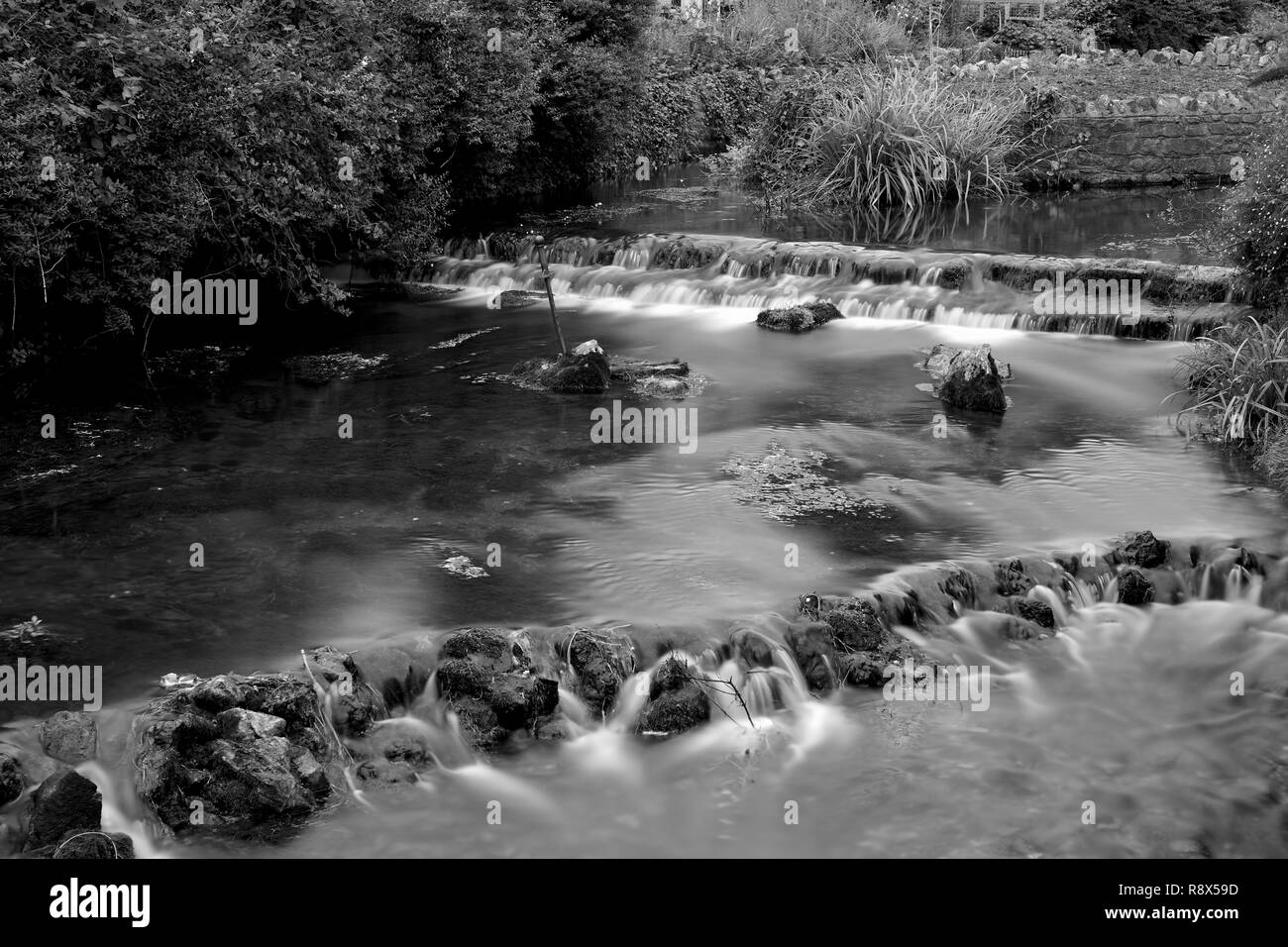 Black and white photo of the river flowing through Cheddar village in somerset Stock Photo