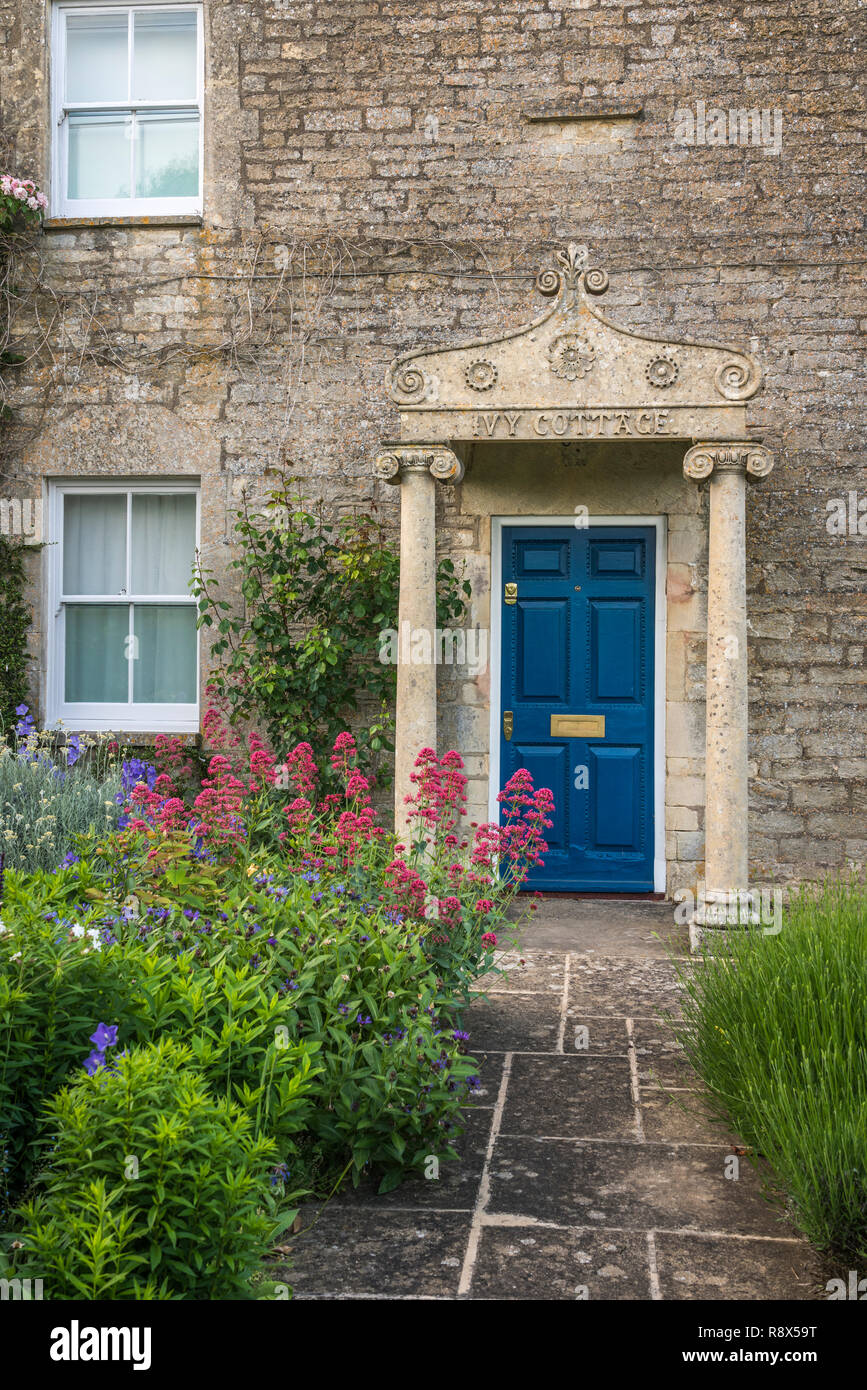 An entrance door in a stone built home in the Cotswold village of Bibery, Gloucestershire, England, Europe. Stock Photo