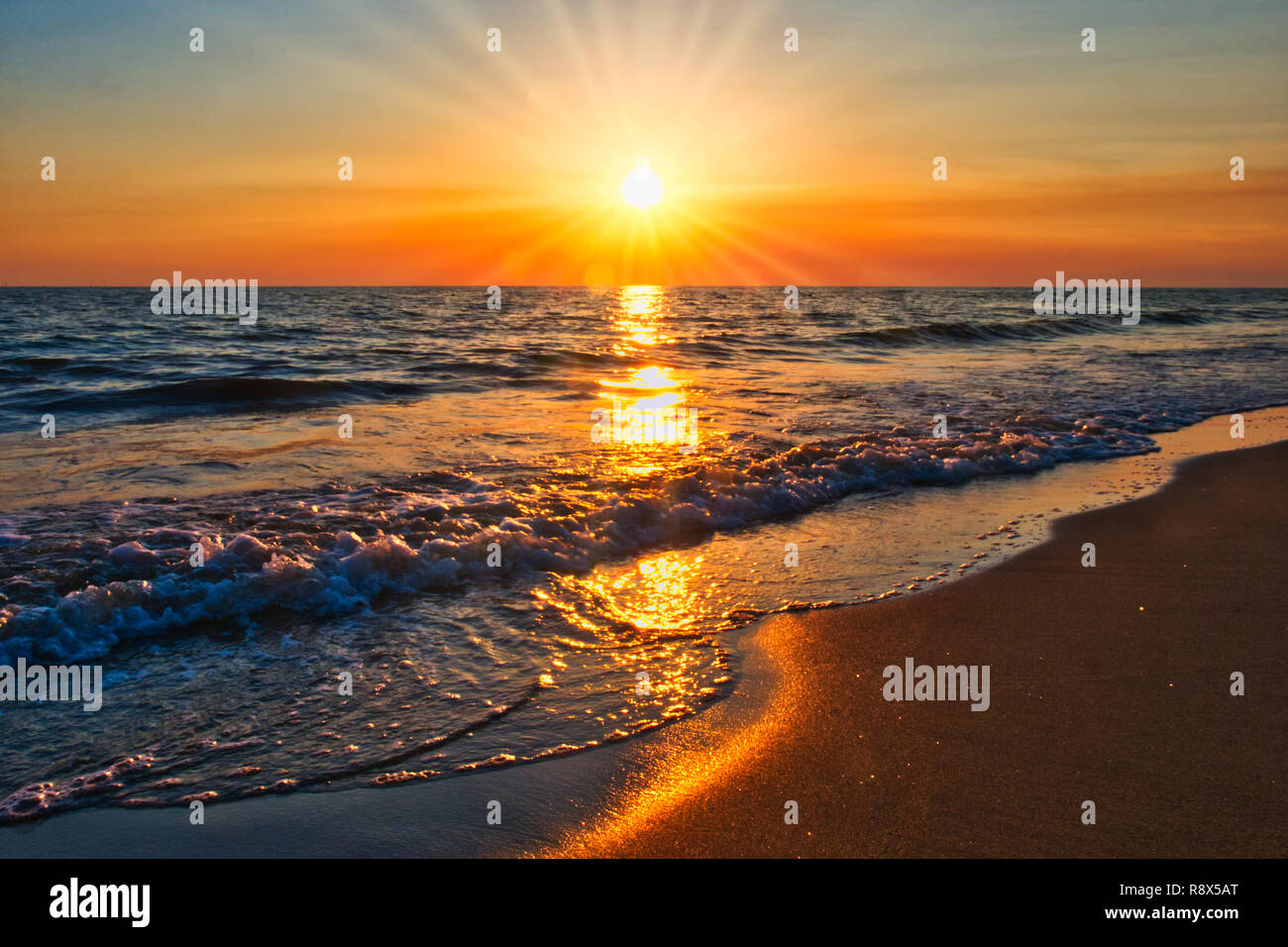 sunset on the beach sunrays Stock Photo