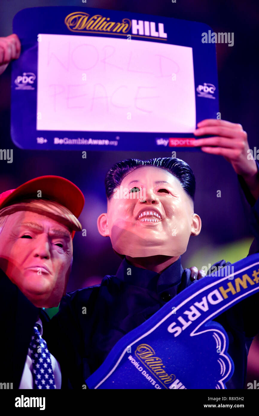 Fans dressed as President of the United States Donald Trump and North Korea President Kim Jong-un during the walk on during day five of the William Hill World Darts Championships at Alexandra Palace, London. Stock Photo