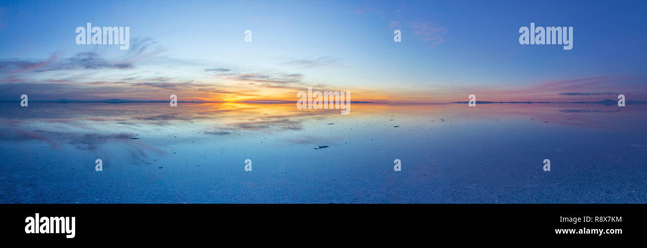 Uyuni reflections. One of the most amazing things that a photographer can see. Here we can see how the sunrise over an infinite horizon at Uyuni Stock Photo