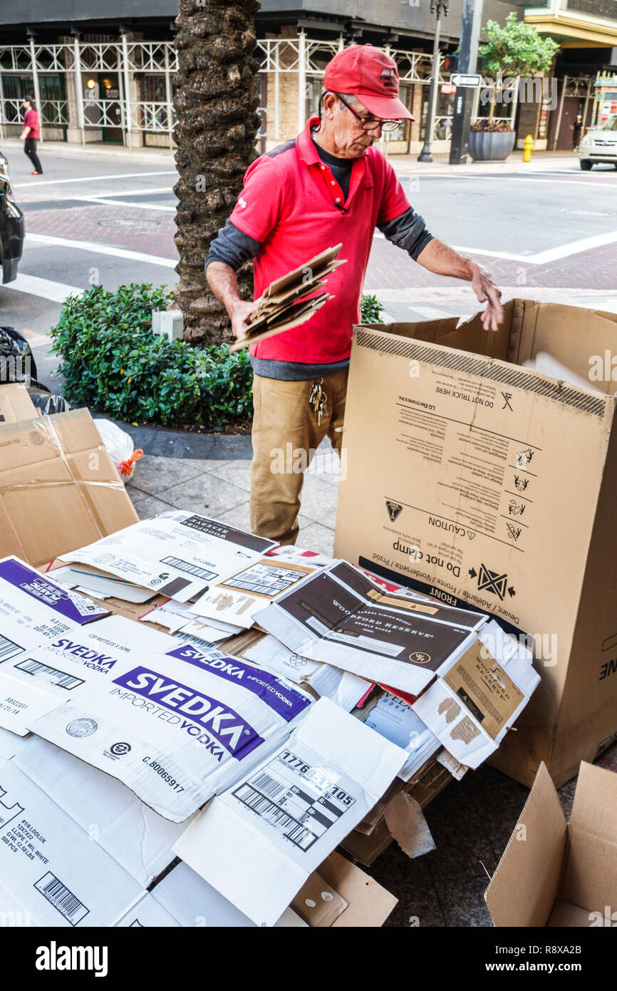 Miami Florida,downtown,Hispanic man men male,breaking down cardboard boxes taking apart,recycling,FL181205076 Stock Photo