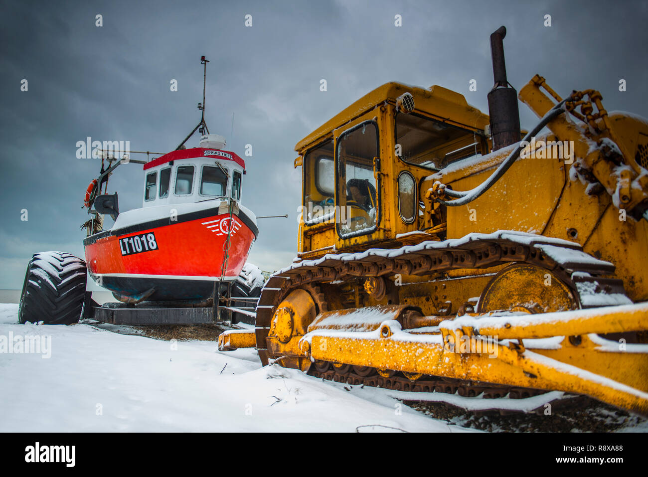 Tractor and Fishing Boats in the snow at Aldeburgh Suffolk England Stock Photo
