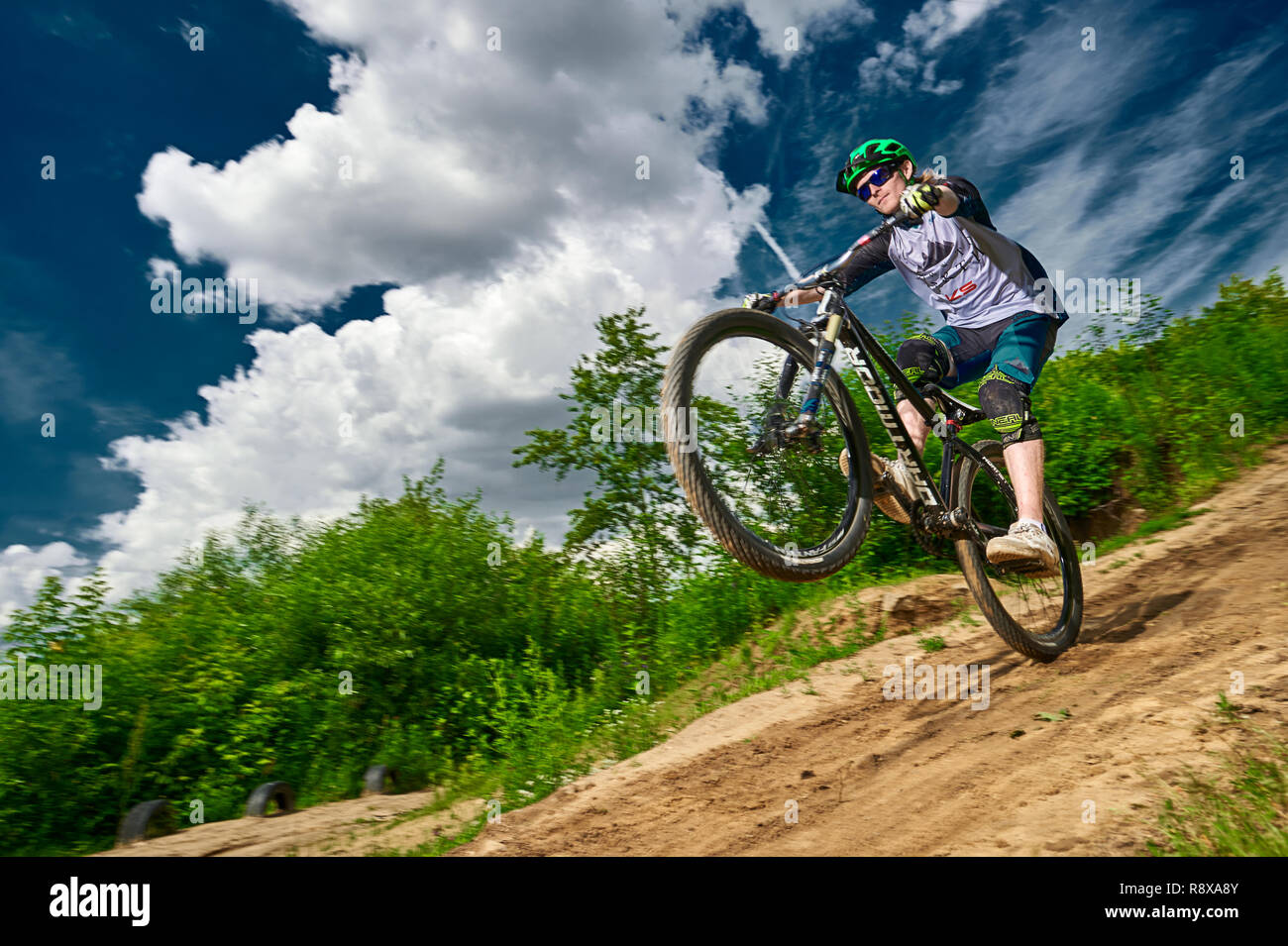 Moscow, Russia - July 6, 2017: Mountain bike cyclist doing wheelie stunt on  a mtb bike. Biker riding extreme sport bicycle. Cool athlete cyclist on a  Stock Photo - Alamy