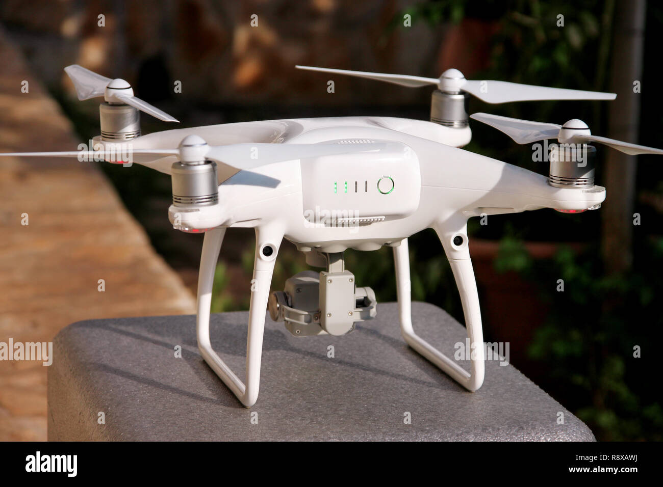 White quadcopter Drone with 4K digital camera on stand is ready for take  off to fly in air to take photos, record footage from above. Drone Stock  Photo - Alamy