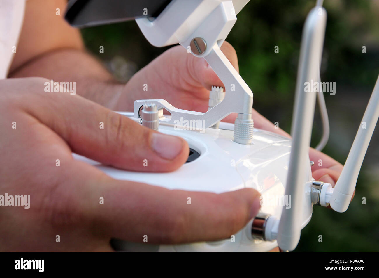 Professional photographer and drone pilot holds remote control panel