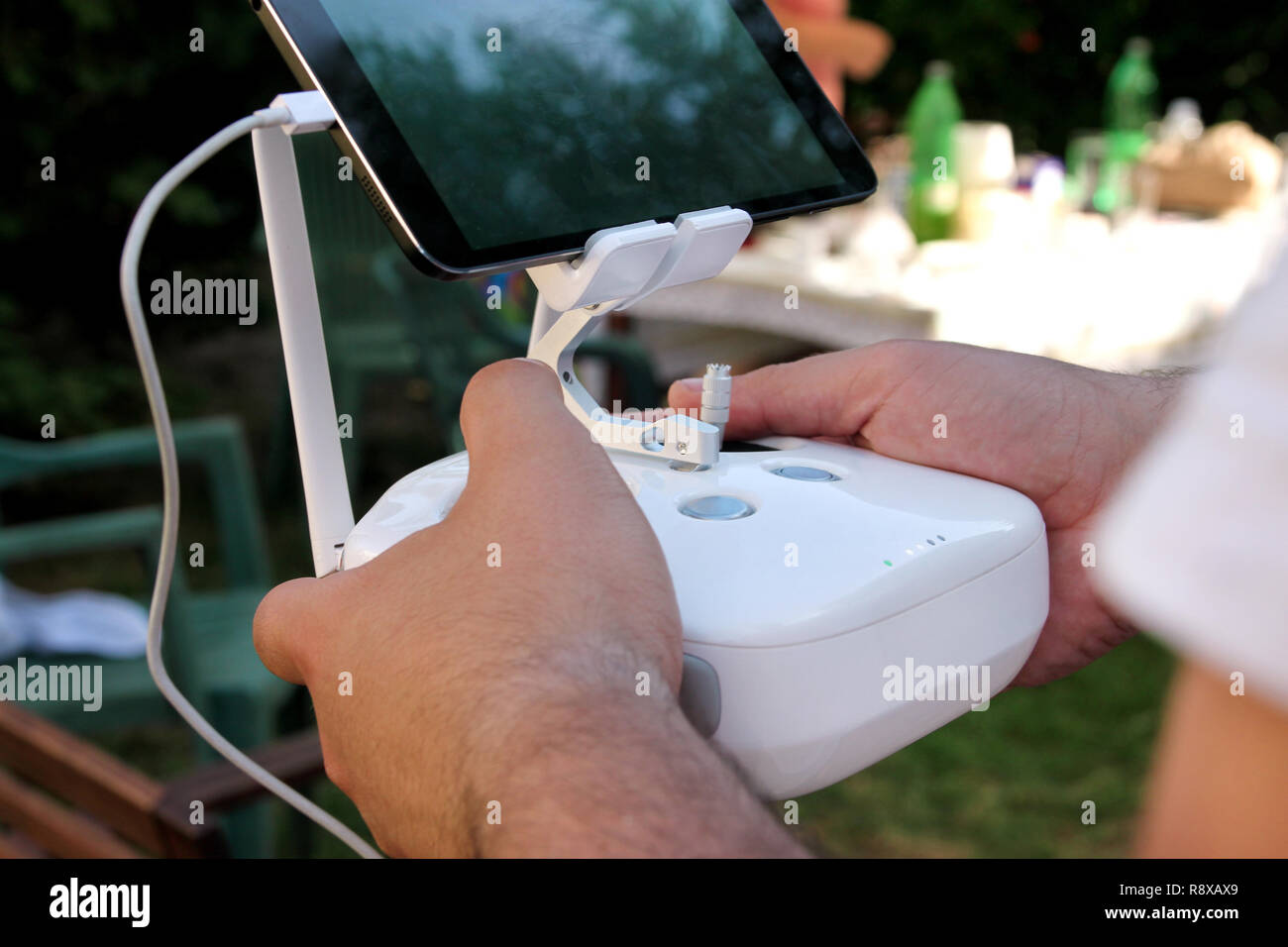 Professional photographer and drone pilot holds remote control panel